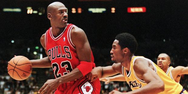 LOS ANGELES, UNITED STATES: Michael Jordan of the Chicago Bulls (L) eyes the basket as he is guarded by Kobe Bryant of the Los Angeles Lakers during their 01 February game in Los Angeles, CA. Jordan will appear in his 12th NBA All-Star game 08 February while Bryant will make his first All-Star appearance. The Lakers won the game 112-87. AFP PHOTO/Vince BUCCI (Photo credit should read Vince Bucci/AFP/Getty Images)